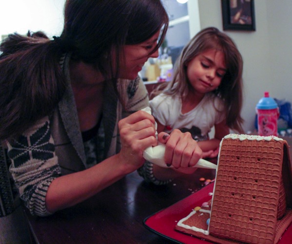 Decorating a gingerbread house with Livi